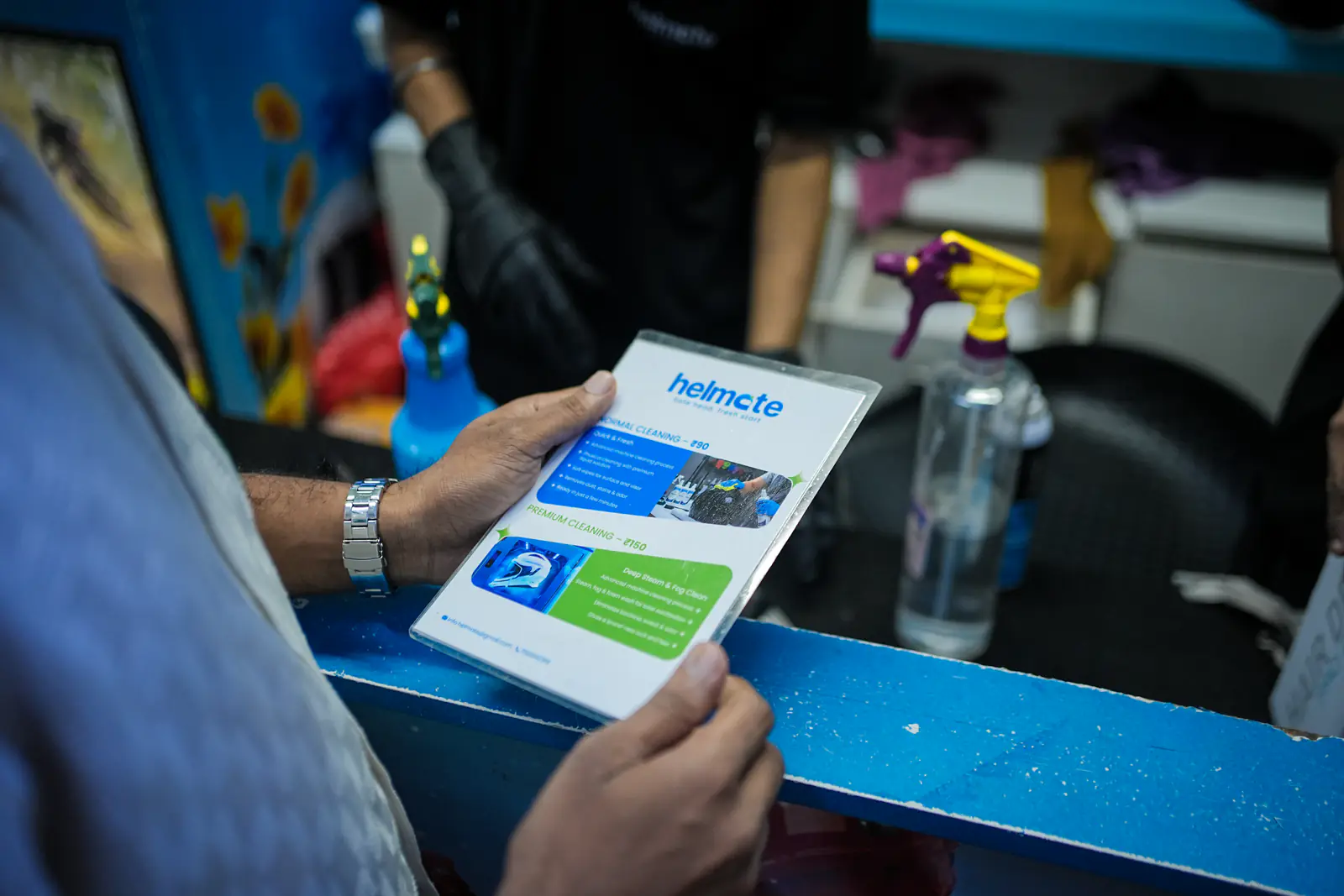 A customer reading the Helmate service card at the counter
