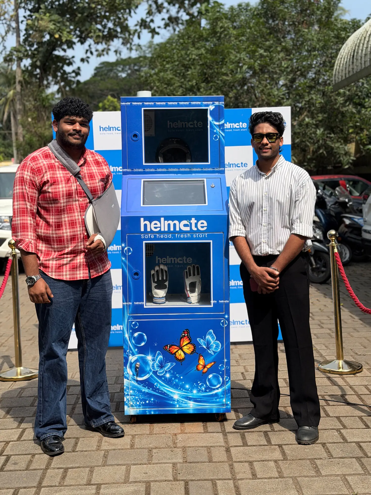 The Helmate team beside a freshly installed machine at an outdoor site
